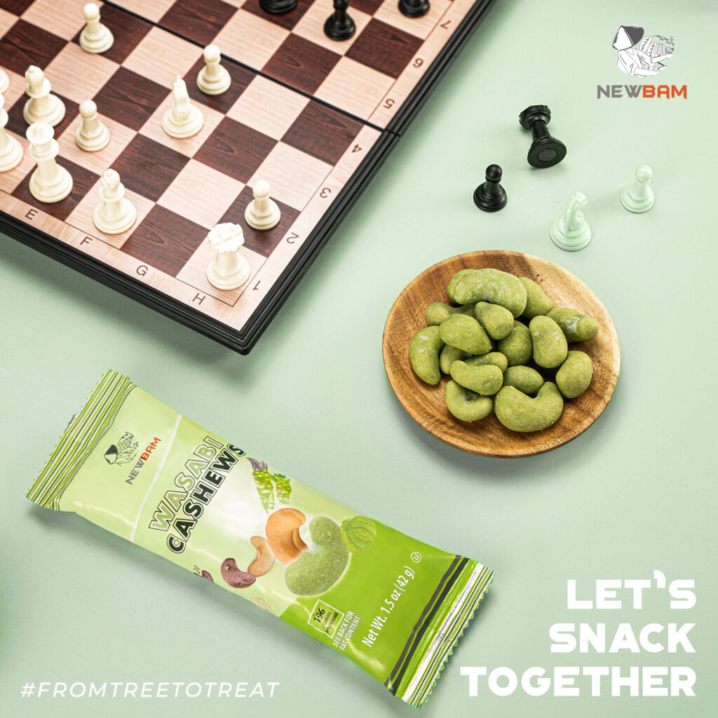 Wasabi-coated cashews and a NEWBAM Wasabi snack pouch beside a chessboard